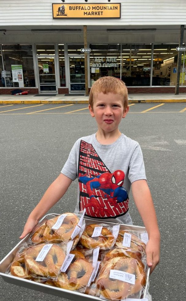 Child holding Buffalo Mountain Market delivery